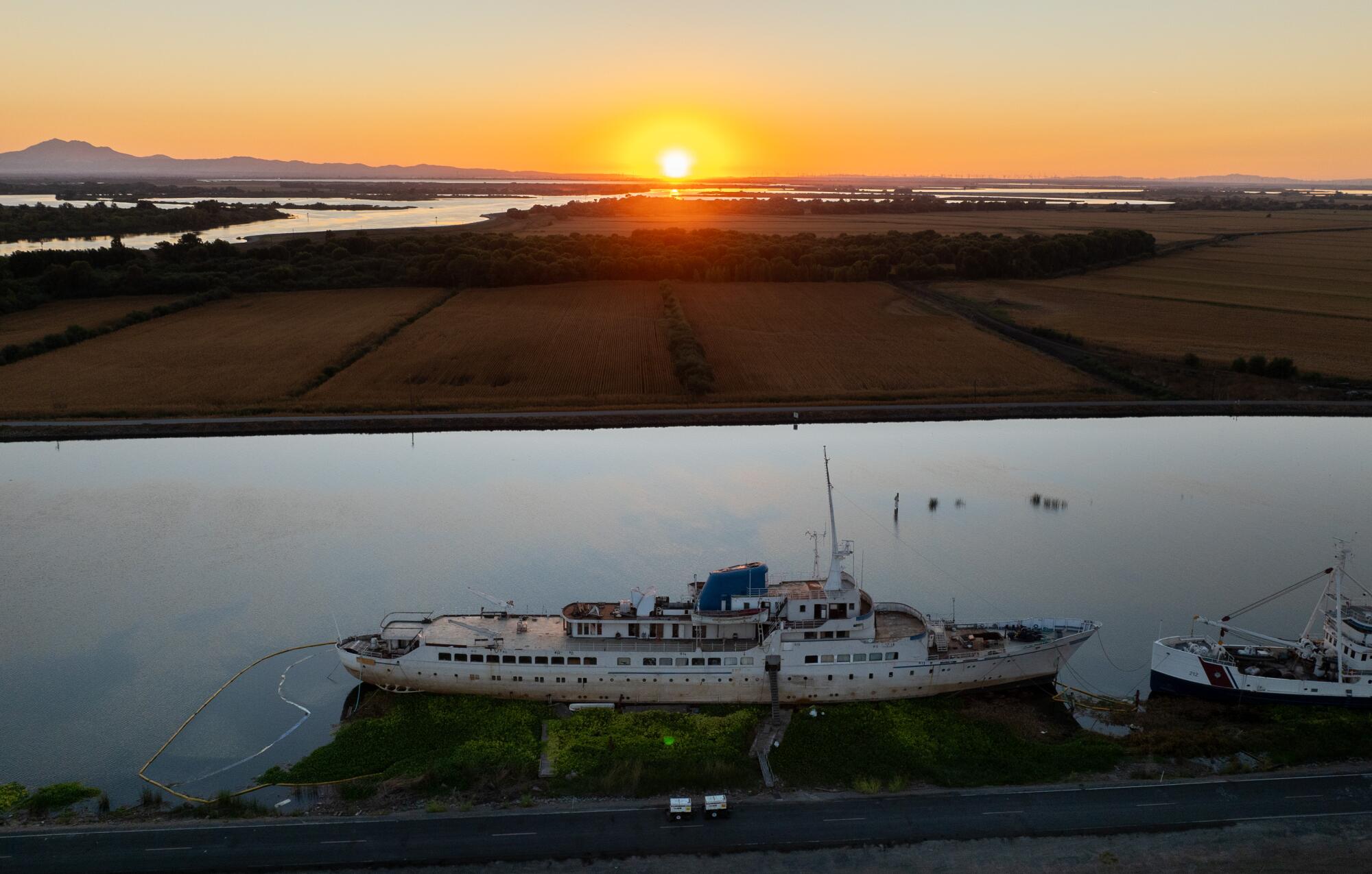 The sun sets behind the Aurora in the rural stretches of Little Potato Slough.