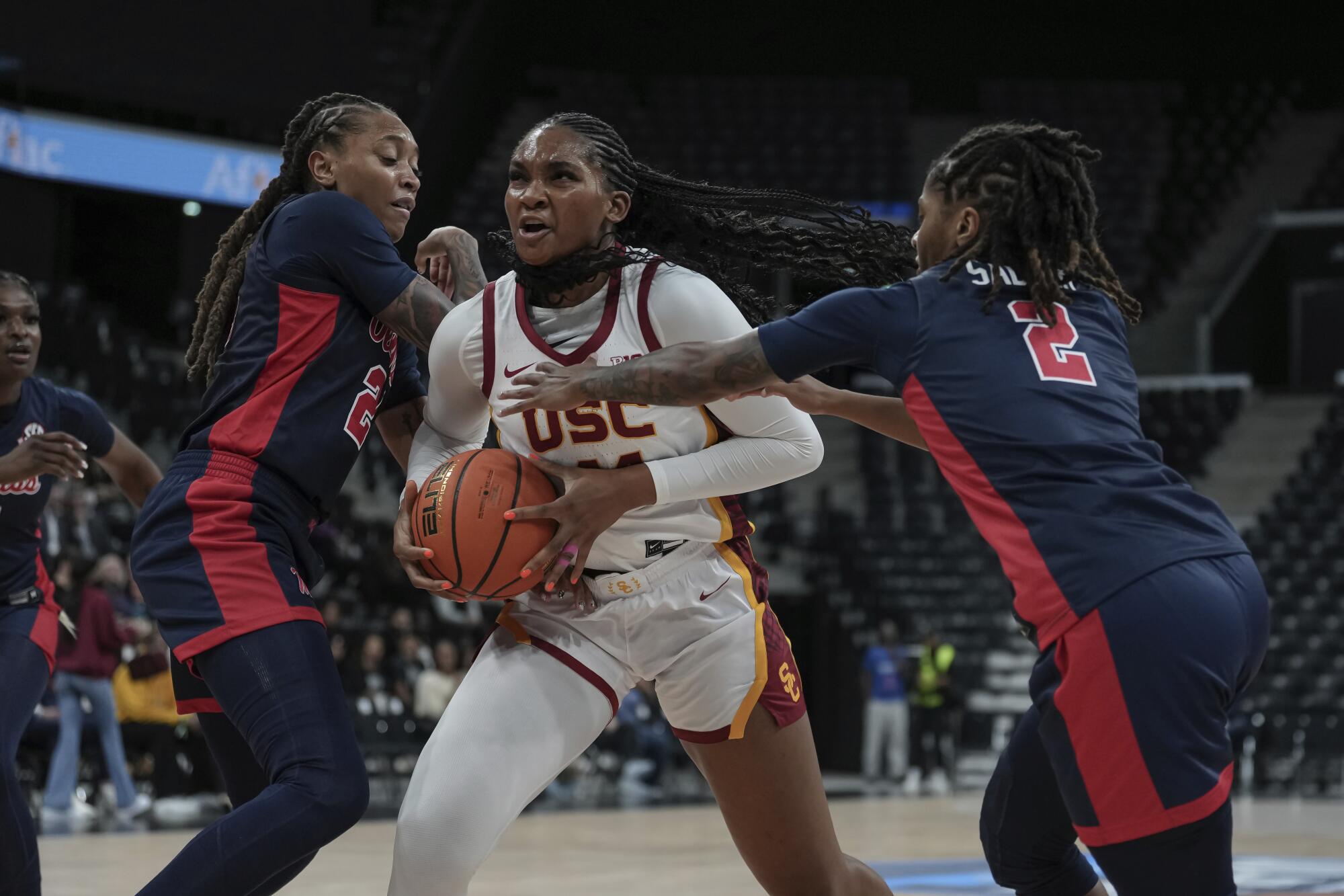 USC forward Kiki Iriafen drives to the basket under pressure from  Mississippi's Madison Scott and Tameiya Sadler