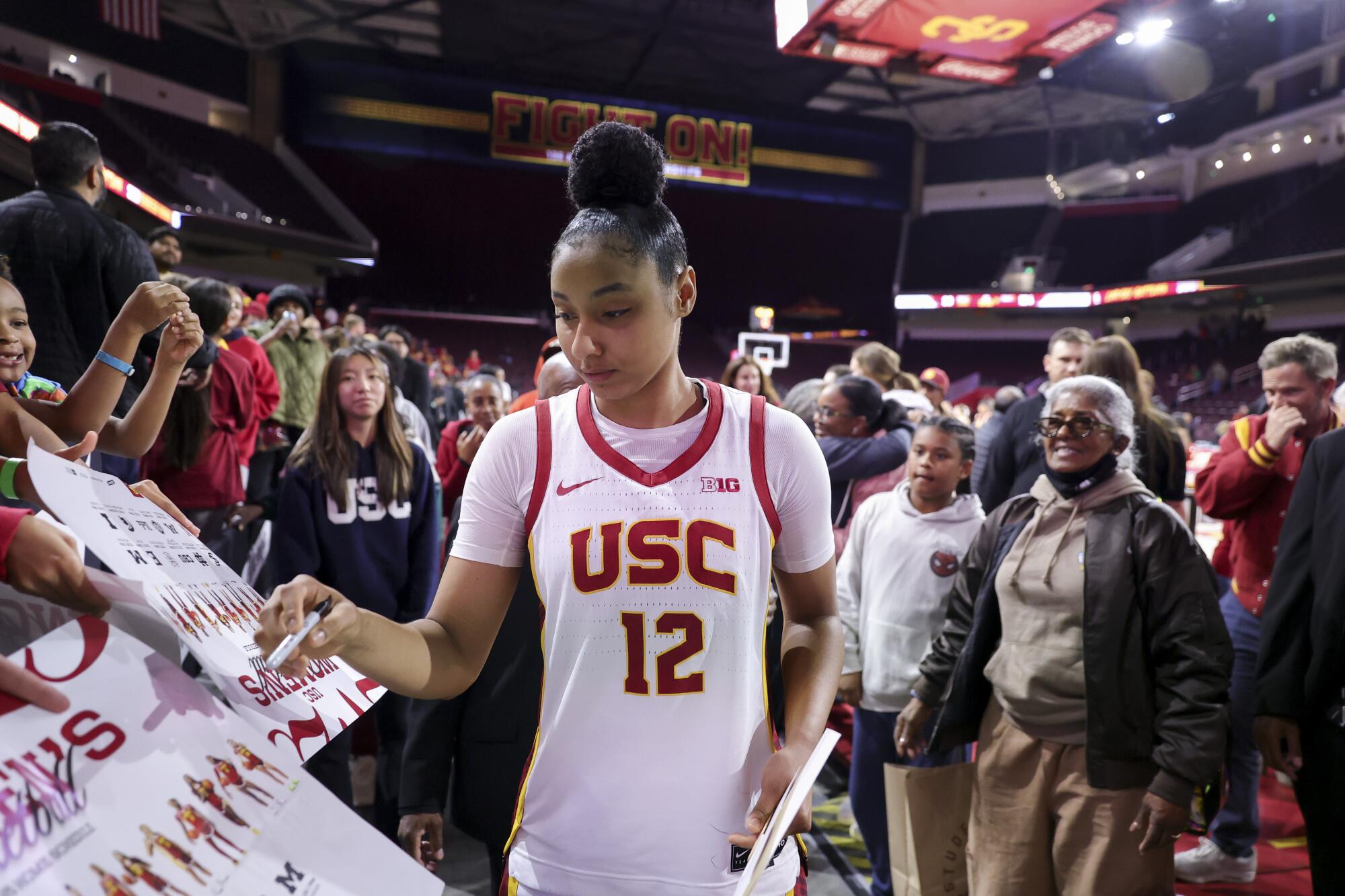 USC guard JuJu Watkins is surrounded by fans as she signs autographs after the Trojans beat Cal State Northridge