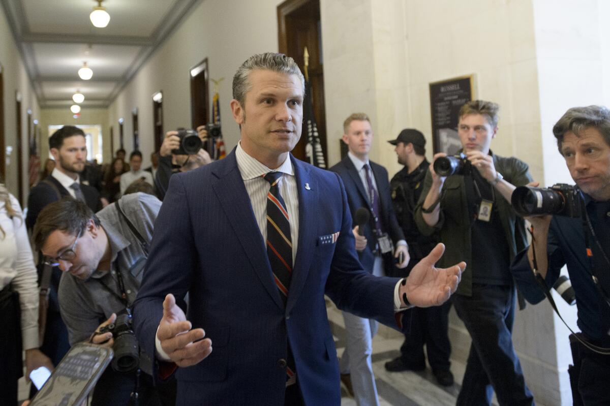 Pete Hegseth, President-elect Donald Trump's pick for secretary of Defense, speaks with reporters in Washington on Thursday.