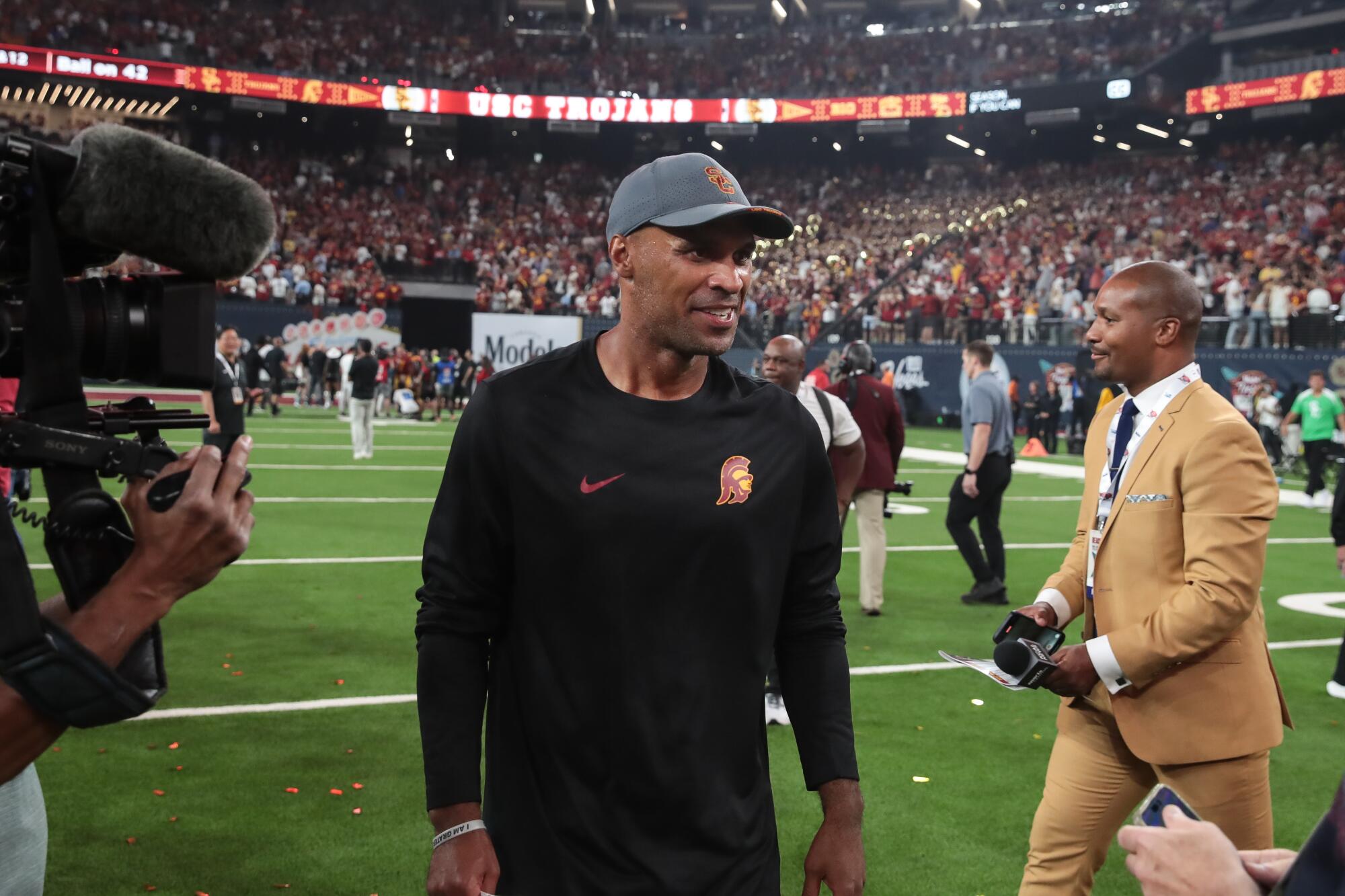 USC defensive coordinator D'Anton Lynn walks on the field during a win over Louisiana State in Las Vegas on Sept. 1.