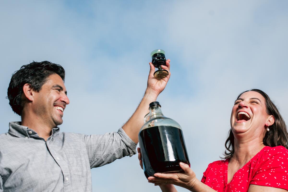 Michael Purtill and Corrine Purtill with a jug of dark beverage