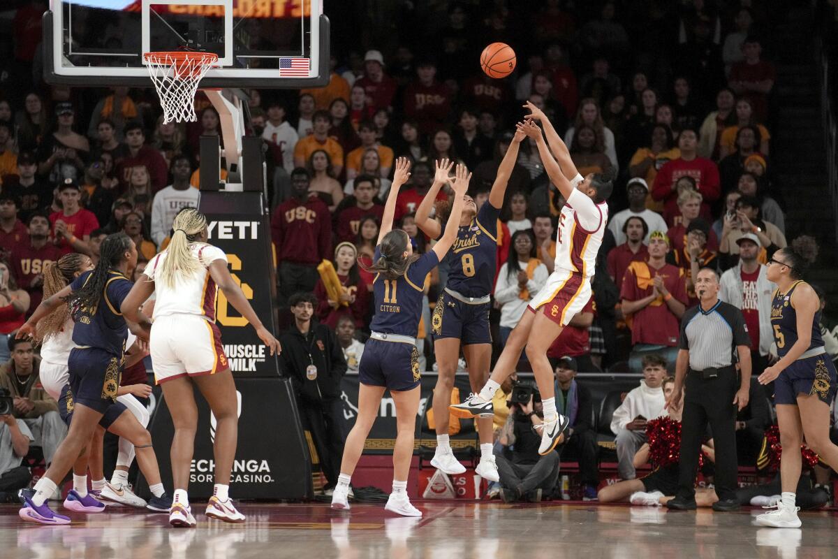 USC guard JuJu Watkins shoots over Notre Dame guards Cassandre Prosper and Sonia Citron.