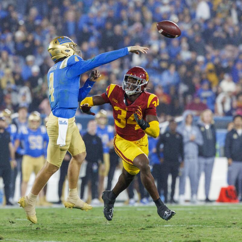 UCLA quarterback Ethan Garbers passes in front of defensive end Braylan Shelby./