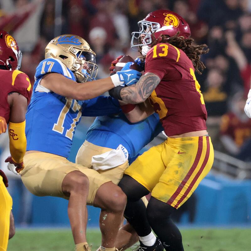 Pasadena, California November 23, 2024- UCLA' receiver Logan Loya prevents USC's Mason Cobb.