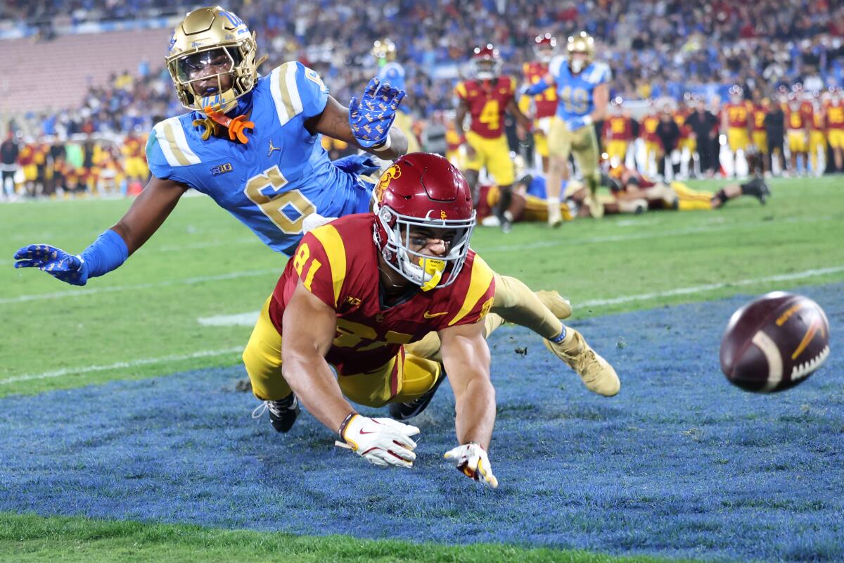 USC wide receiver Kyle Ford can't make the catch in the end zone as UCLA defensive back Jalin Davies defends.