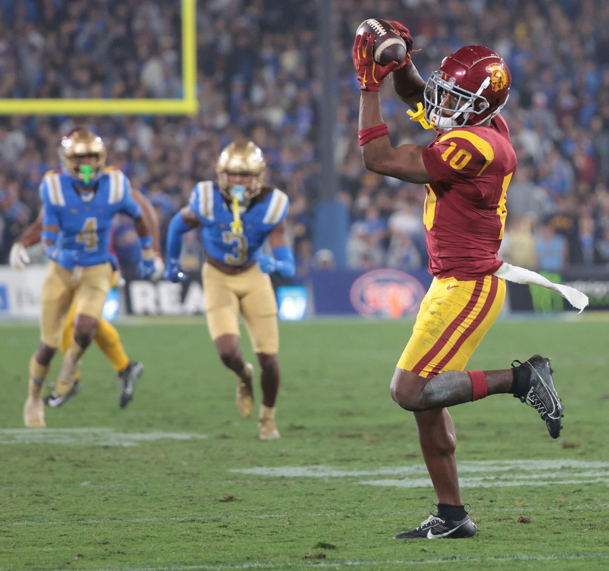 USC receiver Kyron Hudson pulls in a pass from Makai Lemon on a trick play against UCLA in the fourth quarter