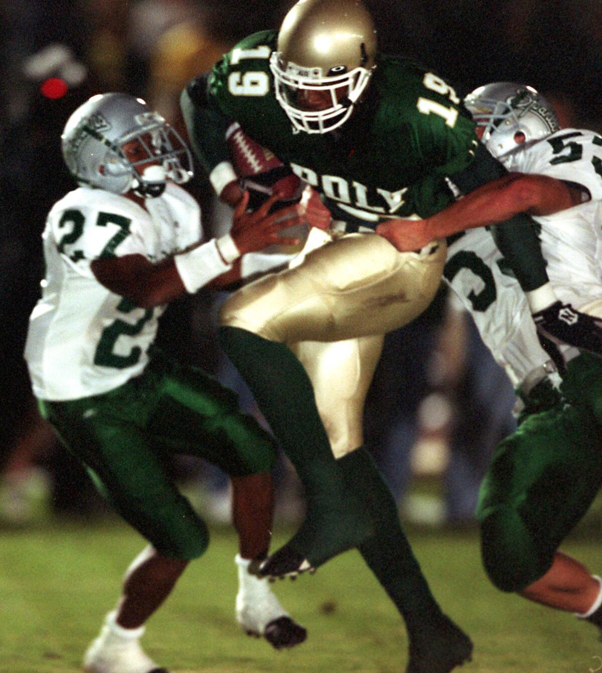 Long Beach Poly tight end Marcedes Lewis runs after a reception against De La Salle in 2001.