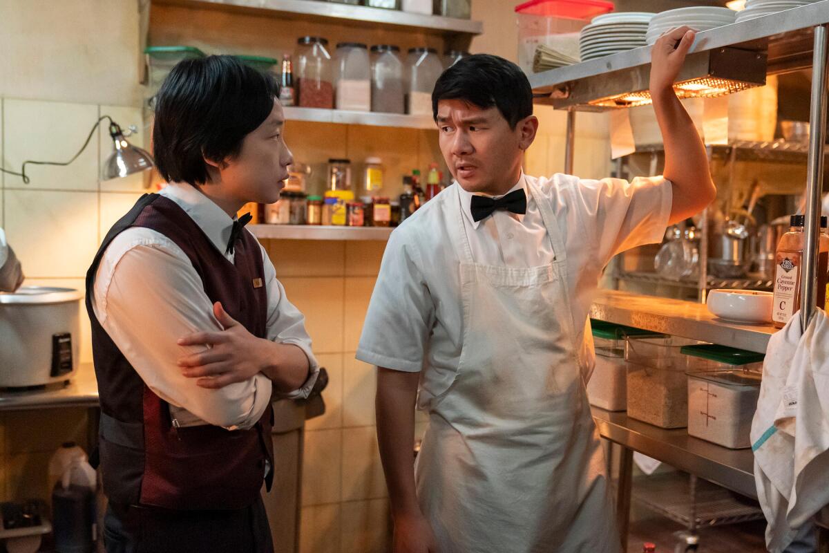 Two men talking in a restaurant kitchen