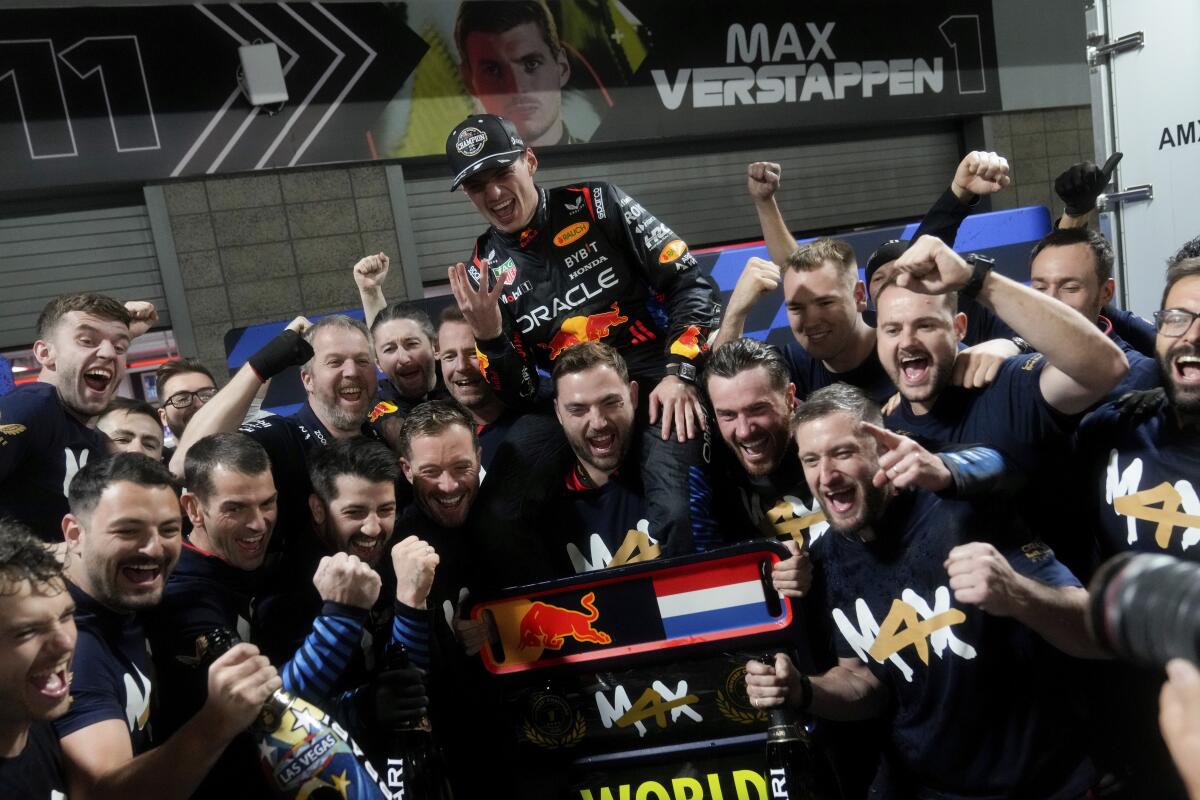 Max Verstappen, top, celebrates with his Red Bull teammates after winning the Formula One drivers' title Saturday night.