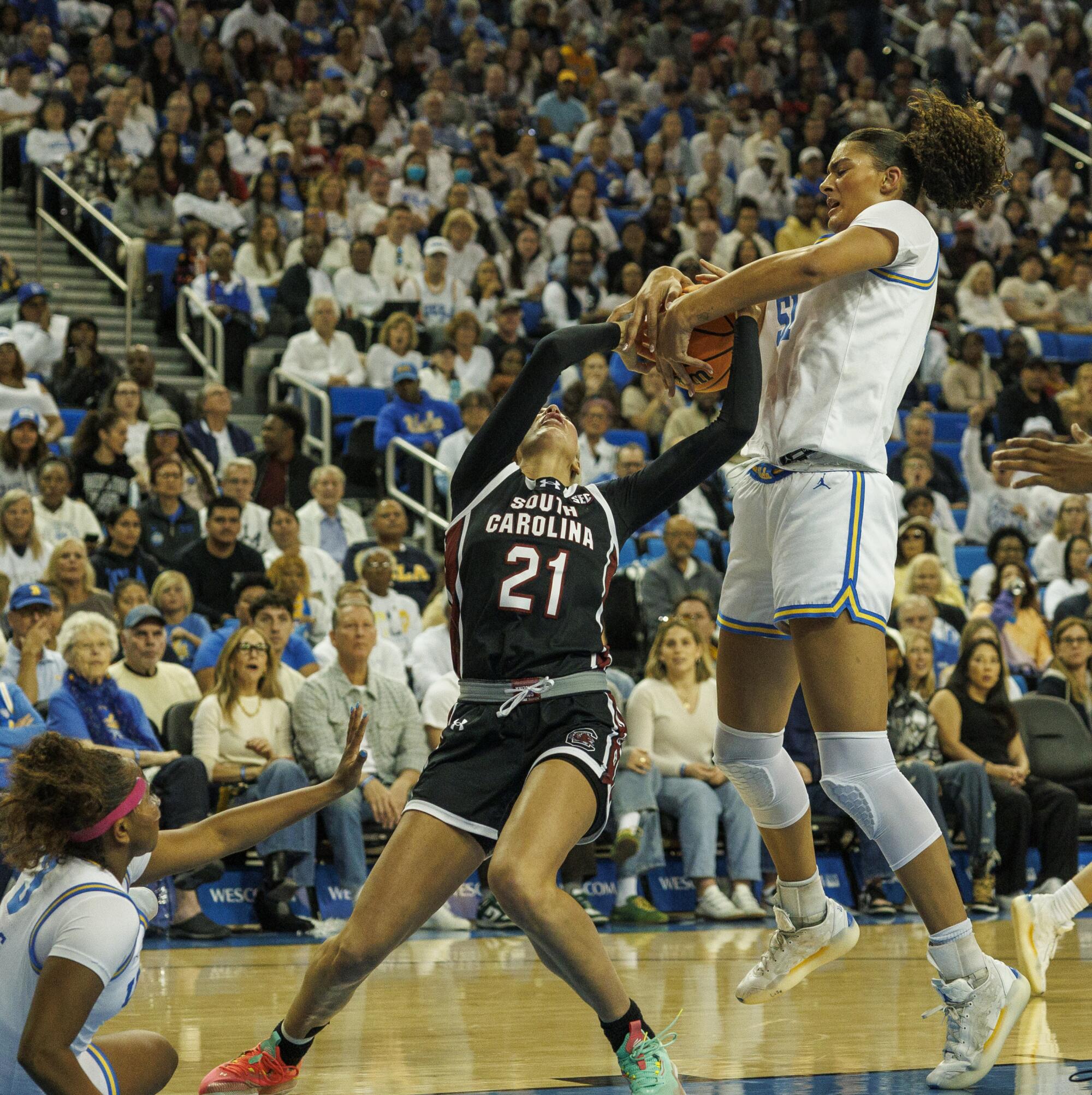 UCLA's Lauren Betts, right, tries to steal the ball from South Carolina's Chloe Kitts.