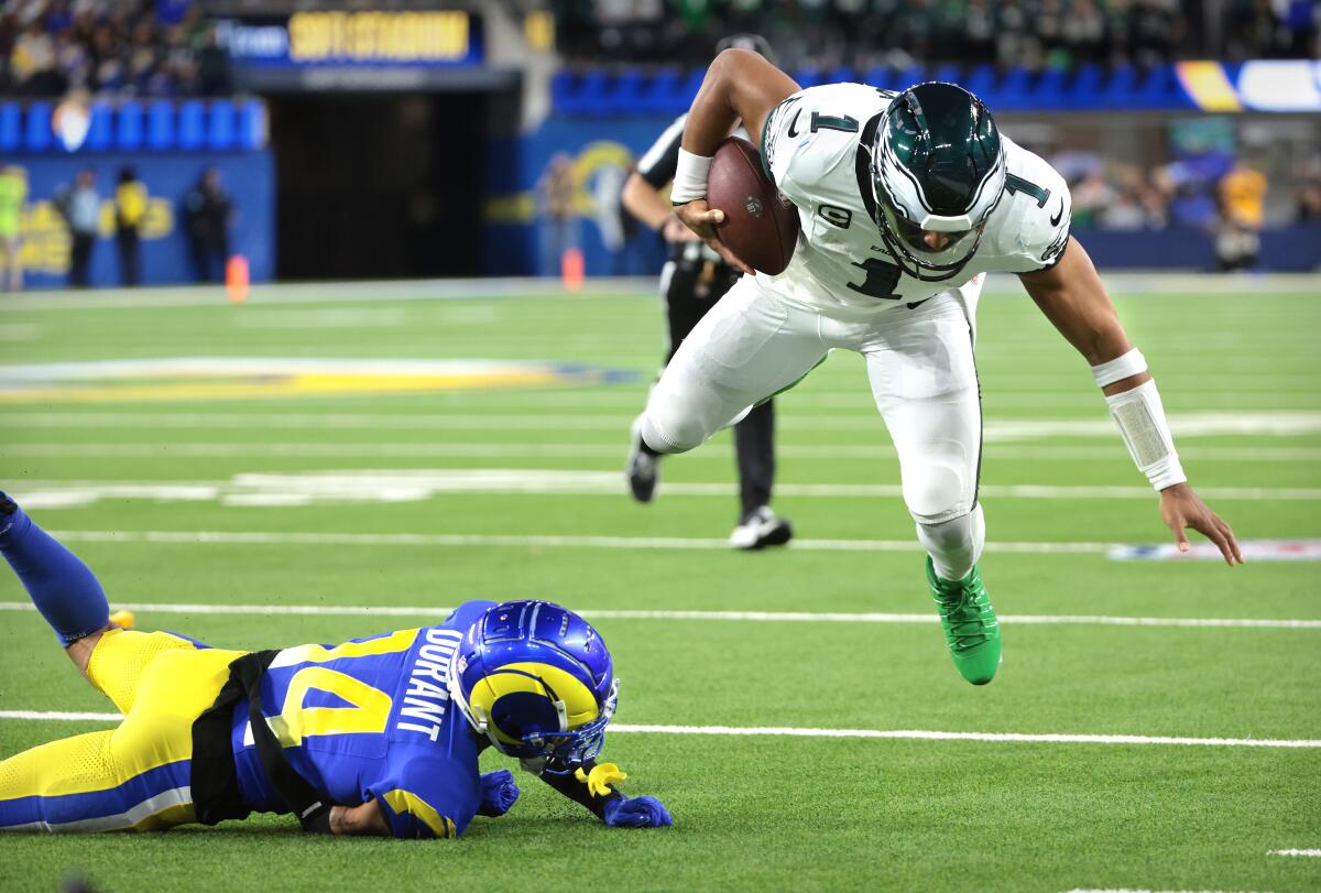 Rams cornerback Cobie Durant trips up Eagles quarterback Jalen Hurts in the second quarter.