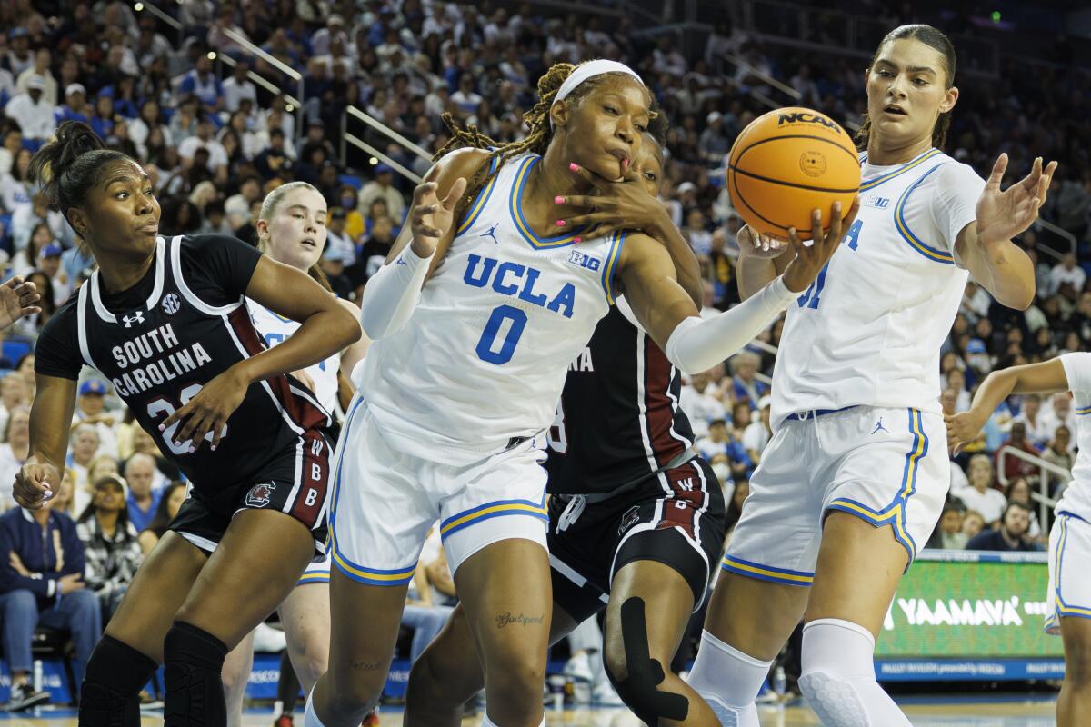 UCLA's Janiah Barker gets hit in the face by South Carolina's Joyce Edwards while trying to grab a rebound.