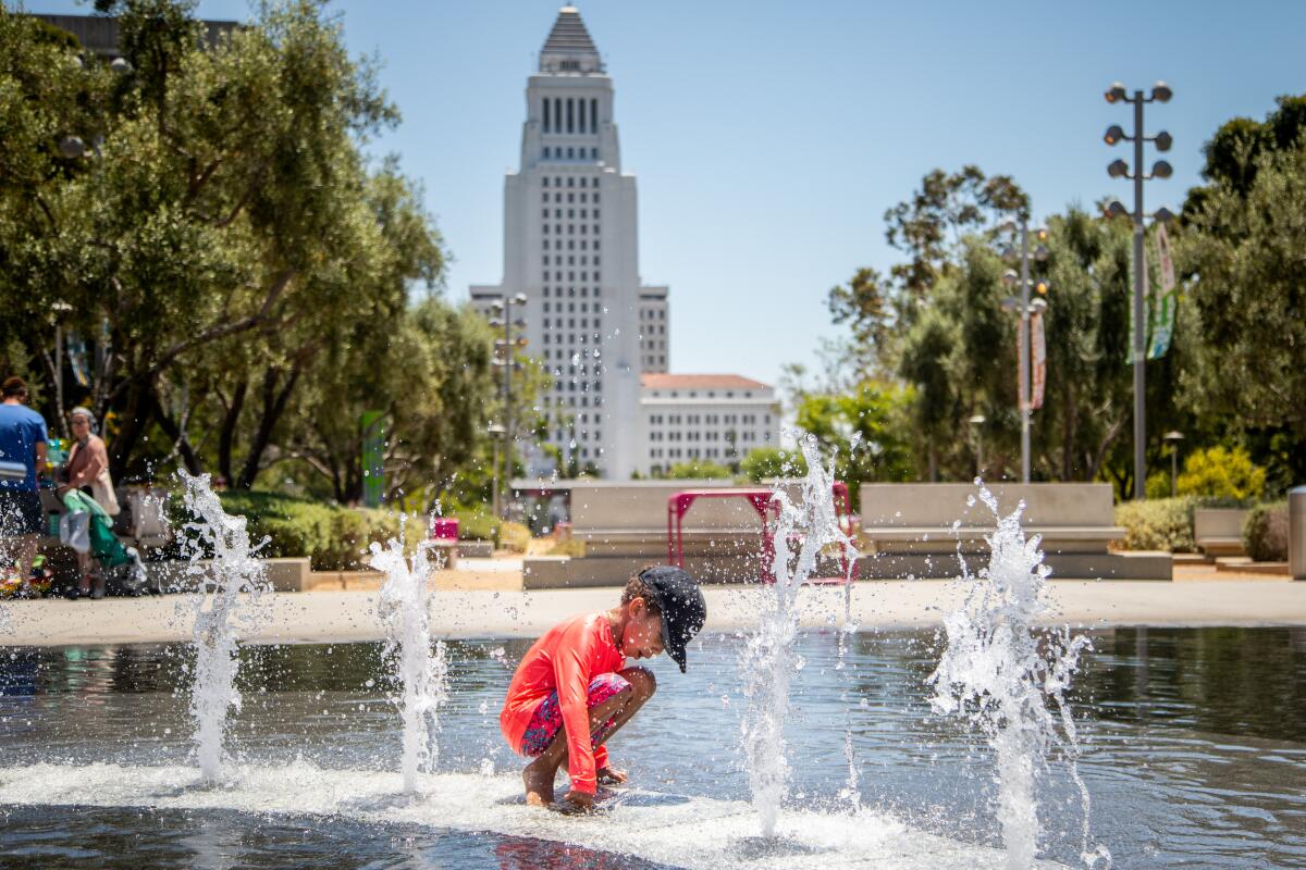 A boy plays in the fountains in Gloria Molina Grand Park in downtown Los Angeles.