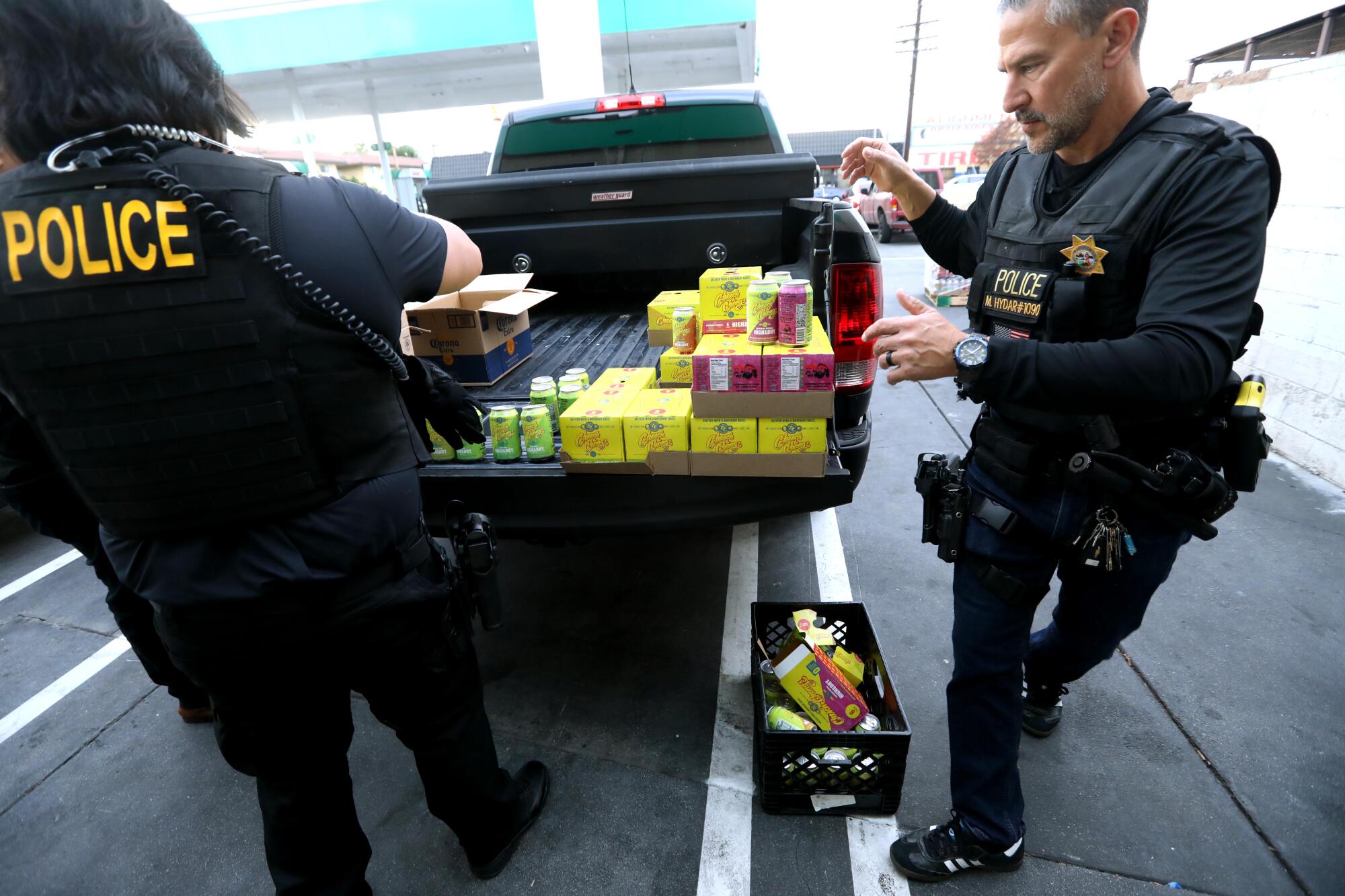 ABC agents count and itemize illegal beverages containing hemp-derived THC that were found at a Dino Mart