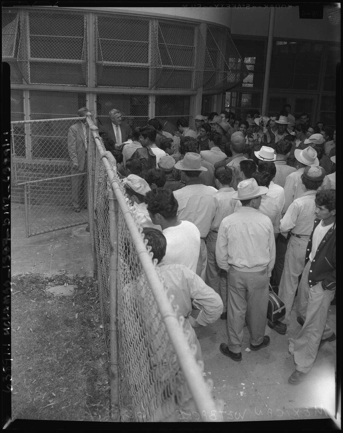 A 1954 photo of Mexican workers awaiting deportation.