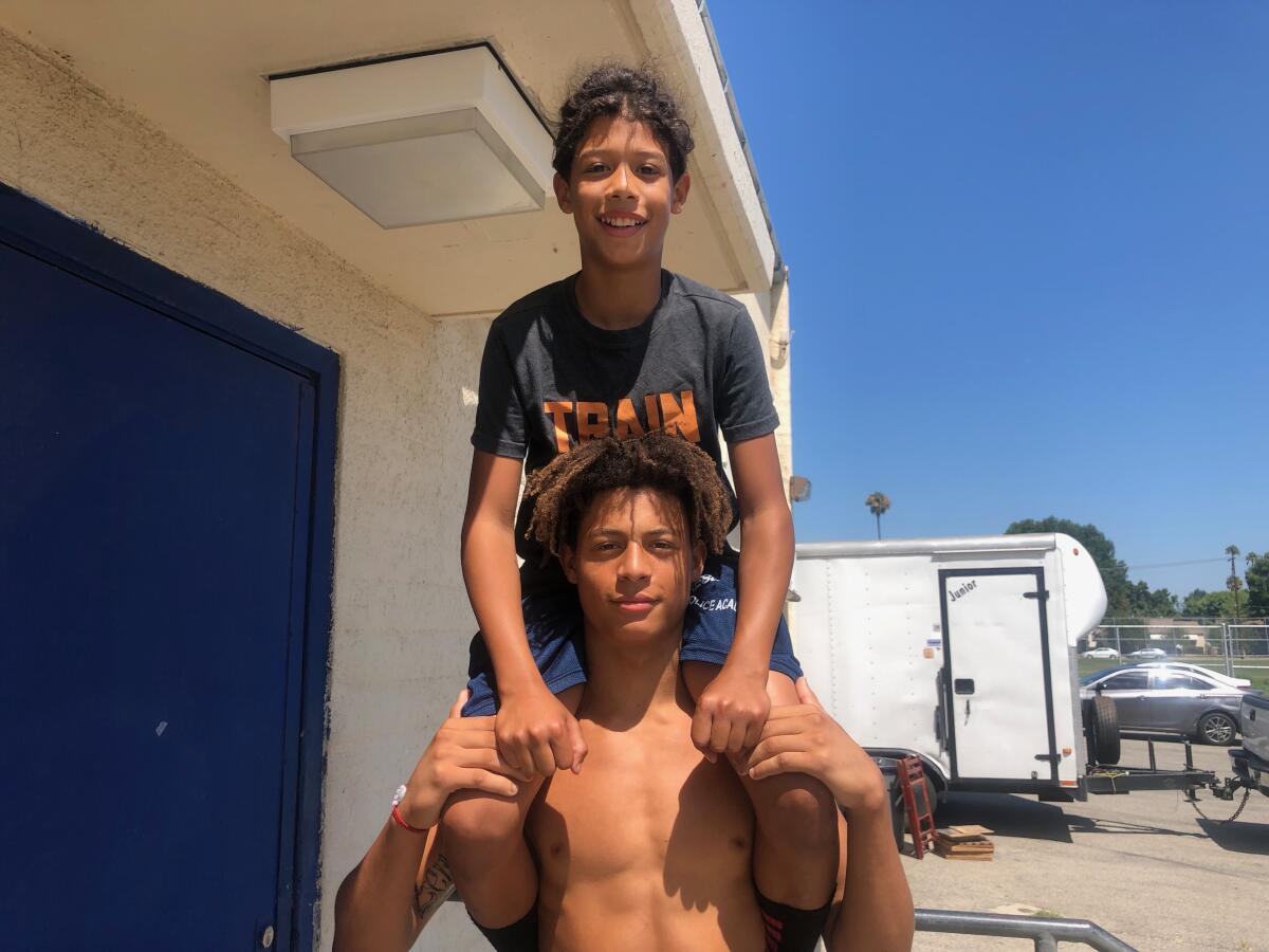 From 2019, Reseda receiver Dranel Rhodes holding up his 12-year-old brother, Amare.