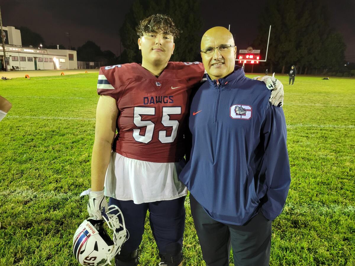 Garfield coach Lorenzo Hernandez and his son, Noah, a starting offensive lineman.