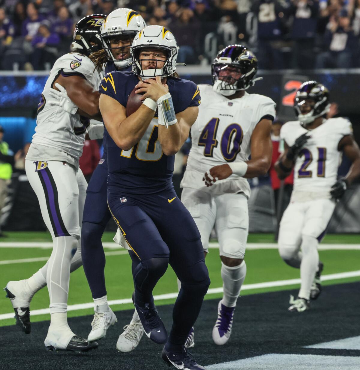 Chargers quarterback Justin Herbert scores on a touchdown run against the Baltimore Ravens at SoFi Stadium on Monday.