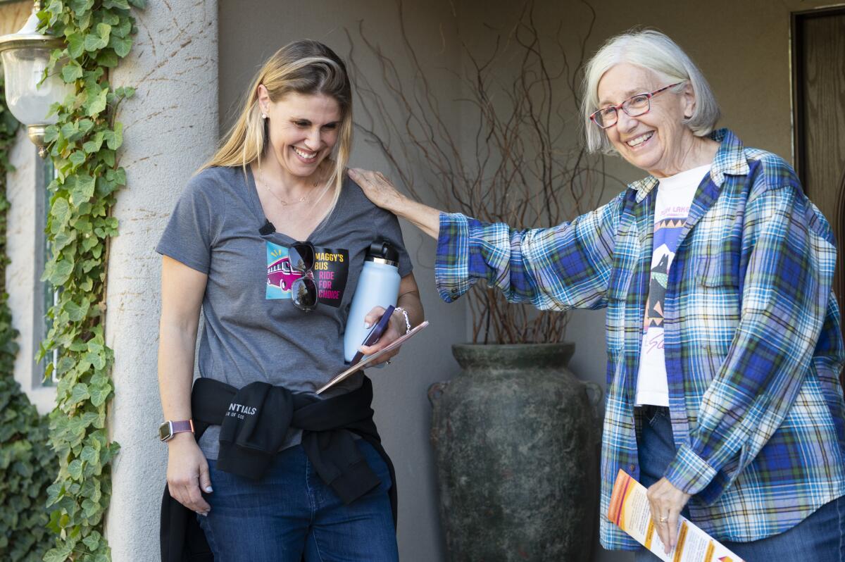 Maggy Krell, left, speaks with Patricia Lynch of Reno while out canvassing in support of Measure 6.