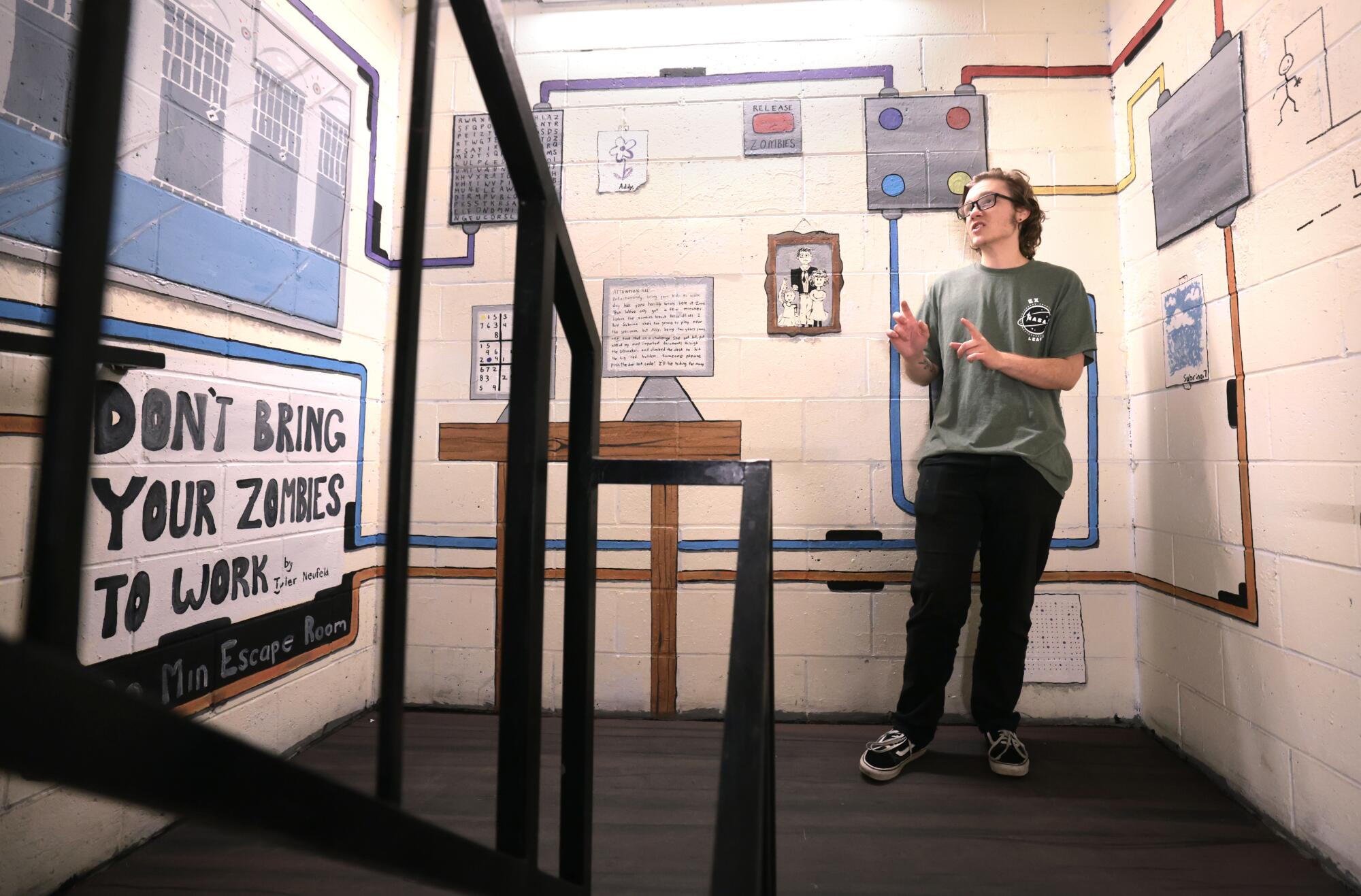 UCLA student Tyler Neufield stands in a stairwell decorated with murals