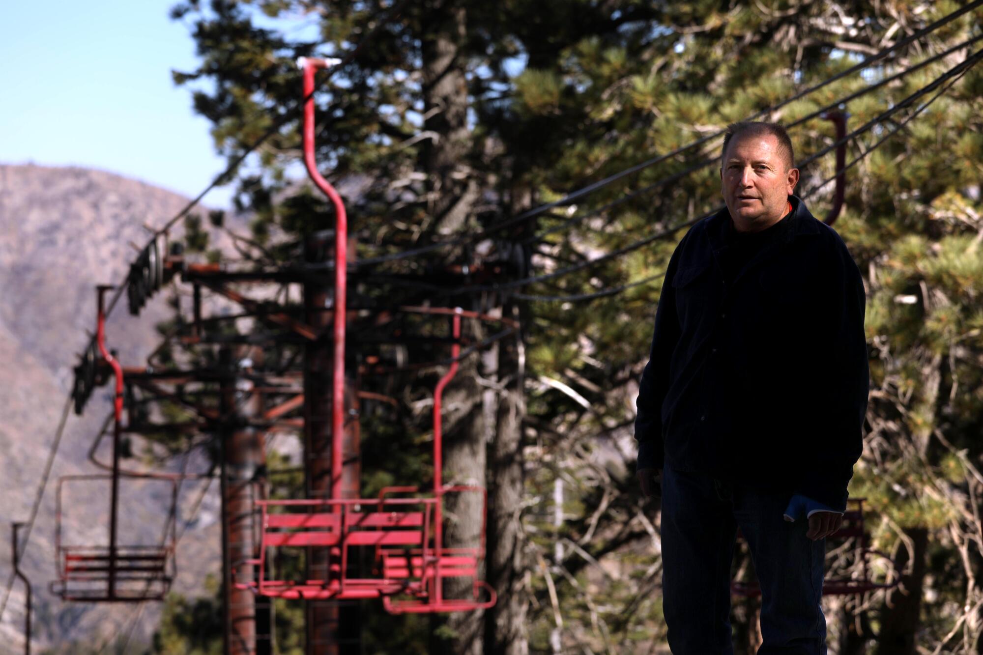 Marc Ramirez stands by an idle ski lift