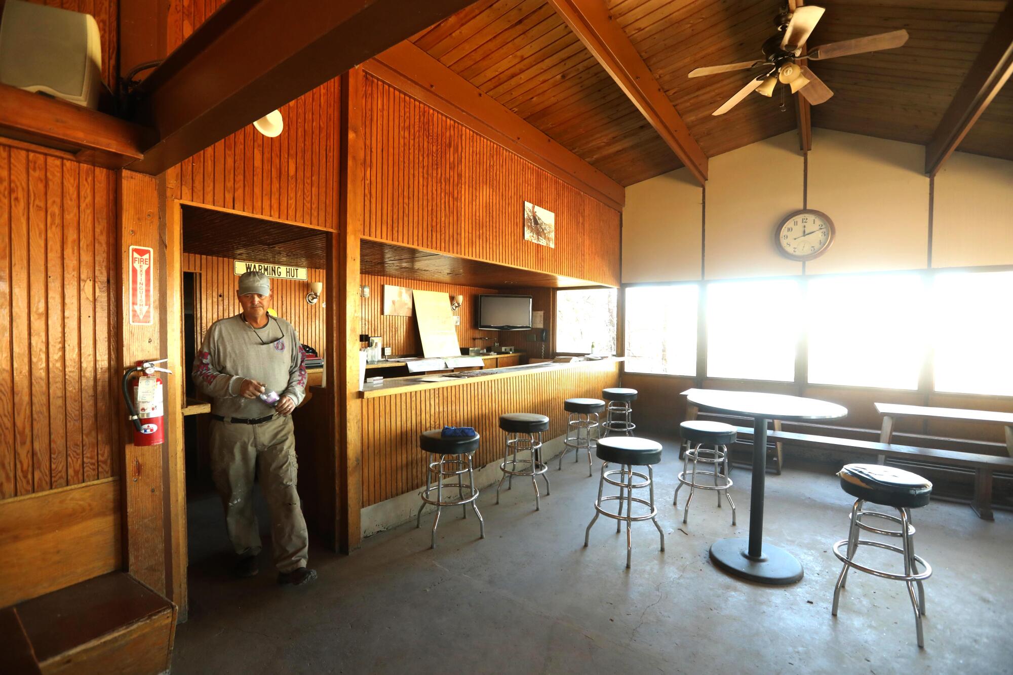 Craig Stewart, a co-owner of Mt. Waterman, walks through the lodge at the resort.