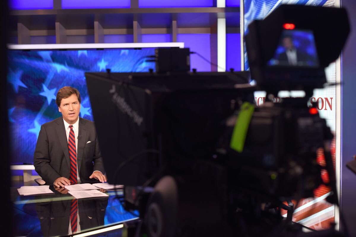 Former prime-time host Tucker Carlson is seen in the studio on the set of his show on Fox News in New York in 2018. 