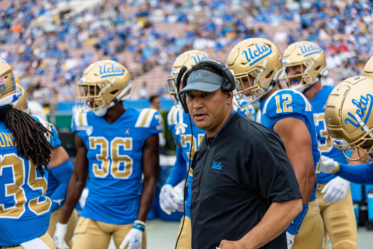 Ikaika Malloe stands on the sidelines during a UCLA football game. 