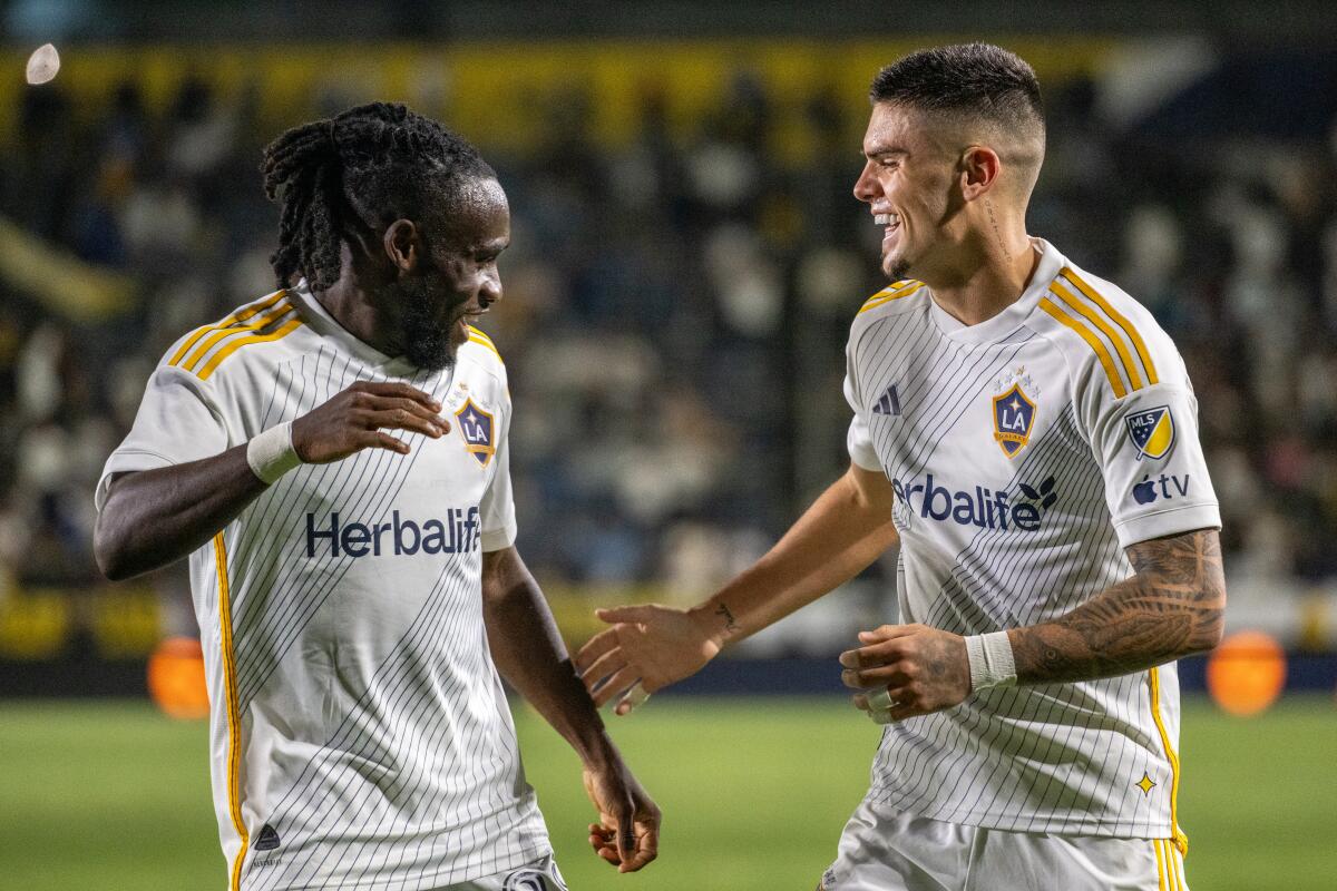 The Galaxy's Joseph Paintsil celebrates with Gabriel Pec after scoring against Sporting Kansas City