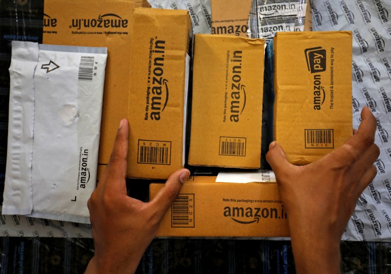 A worker sorts delivery packages in a van outside an Amazon facility in Ahmedabad, India, March 17, 2021. Picture taken March 17, 2021. REUTERS/Amit Dave