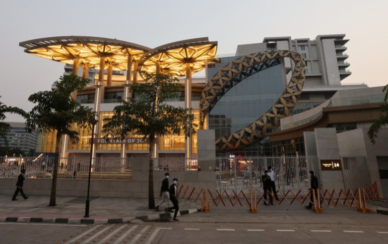 People walk outside a Reliance complex which houses Jio World Plaza mall in Mumbai