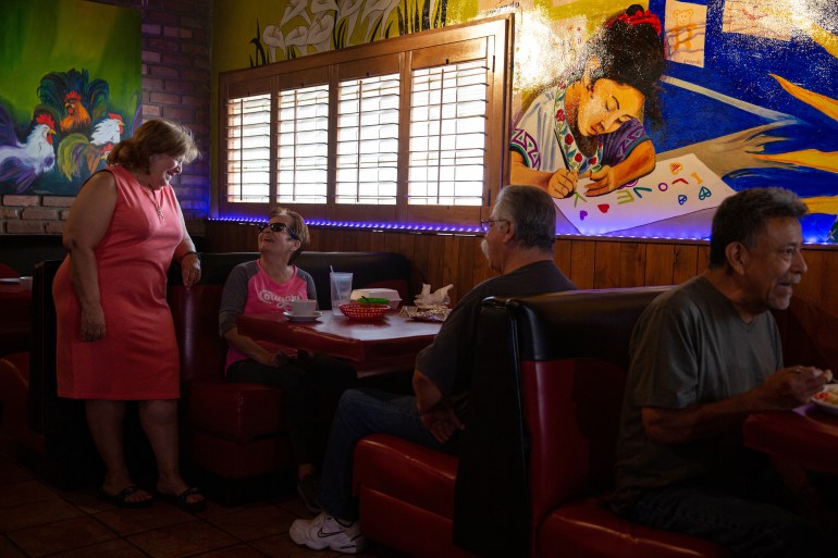 Latino voter and longtime politician Mary Rose Wilcox, left, speaks with regulars at her restaurant El Portal in Phoenix, Arizona, U.S., April 19, 2022. Picture taken April 19, 2022. REUTERS/Caitlin O'Hara