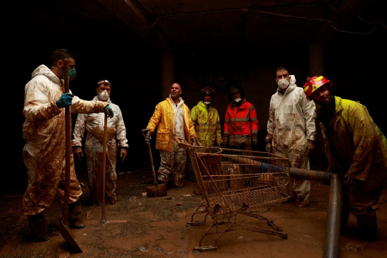 Police and firefighters from Madrid drain a garage following catastrophic flooding, as Spain braces for more torrential rain, in Paiporta, Valencia, Spain November 13, 2024. REUTERS/Vincent West