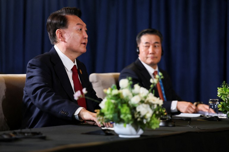 Yoon Suk Yeol and Shigeru Ishiba at a panel table with Joe Biden 