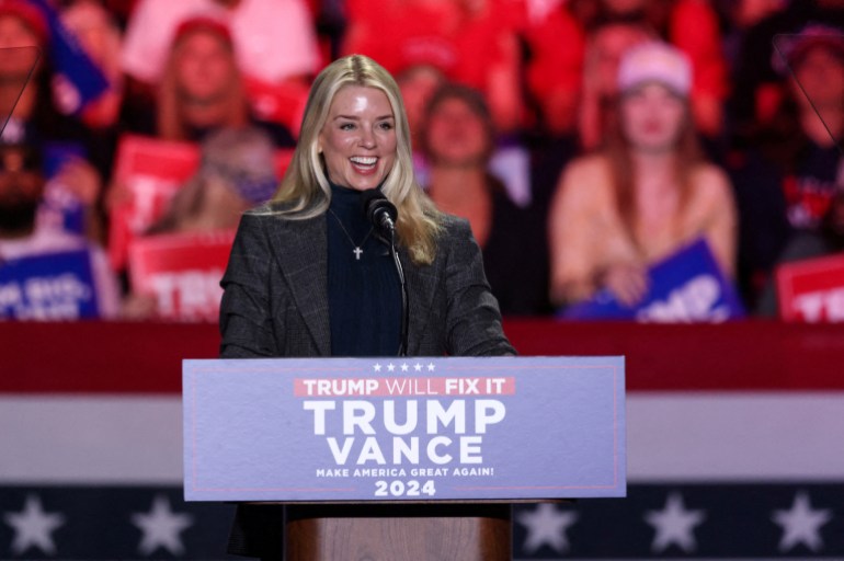 Pam Bondi speaks at a podium during a Trump campaign rally