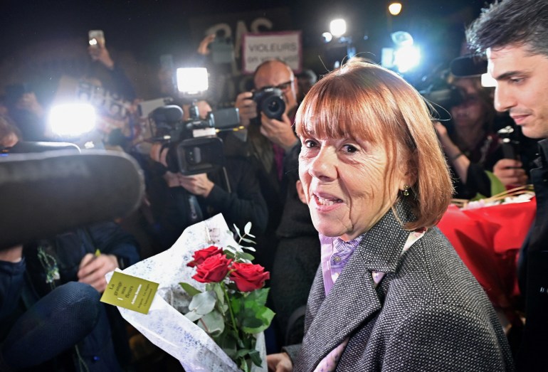 Frenchwoman Gisele Pelicot, the victim of an alleged mass rape orchestrated by her husband Dominique Pelicot at their home in the southern French town of Mazan, carries flowers as he leaves the court after attending the trial for Dominique Pelicot and 50 co-accused, at the courthouse in Avignon, France, November 25, 2024. REUTERS/Alexandre Dimou