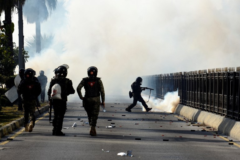 Security force personnel fire tear gas shells to disperse the supporters of the former Pakistani Prime Minister Imran Khan's party, Pakistan Tehreek-e-Insaf (PTI), during a protest to demand the release of Khan, in Islamabad, Pakistan, November 26, 2024. REUTERS/Stringer