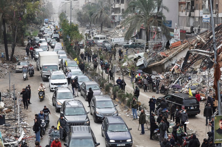 Cars drive past rubble from damaged buildings in Beirut's southern suburbs, after a ceasefire between Israel and Iran-backed group Hezbollah took effect at 0200 GMT on Wednesday after U.S. President Joe Biden said both sides accepted an agreement brokered by the United States and France, in Lebanon, November 27, 2024. REUTERS/Mohamed Azakir