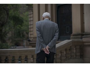 A man stands on a street in Sydney, Australia, on Tuesday, Nov. 28, 2023. Australia plans to enshrine an objective of superannuation in legislation as part of its agenda to maximize the benefits of the nations pension system, Treasurer Jim Chalmers said in a statement on Nov. 16. Photographer: Brent Lewin/Bloomberg