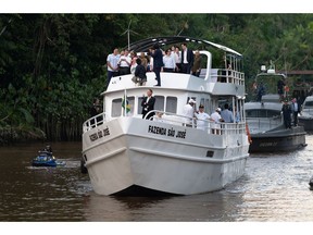 Luiz Inácio Lula da Silva, Brazil's president, top center, and Emmanuel Macron, France's president, top center left, sail to visit Combu Island near Belem on March 26, 2024.  Photographer: Alessandro Falco/Bloomberg