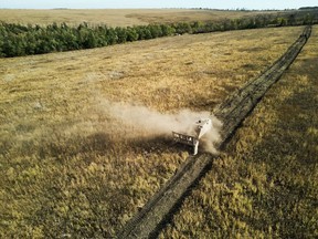 Demining teams from Ukraine's State Emergency Service clear a field using a remote-controlled GCS-200 mine-clearing vehicle in Svyatohirsk, Ukraine.