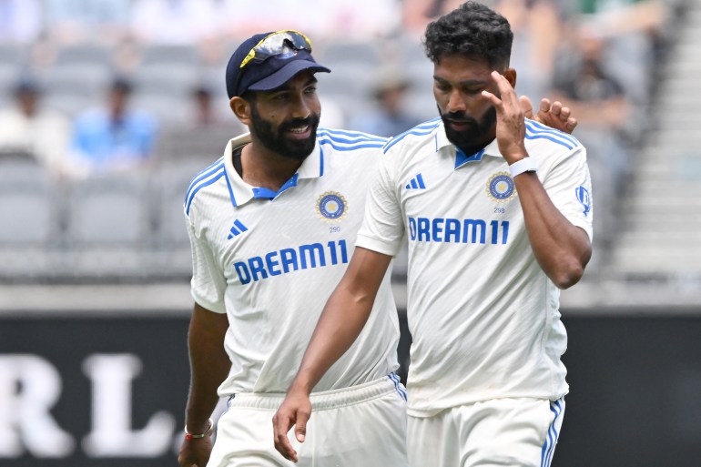 India's skipper Jasprit Bumrah (L) talks with paceman Mohammed Siraj on day four of the first Test cricket match between Australia and India at Optus Stadium in Perth on November 25, 2024. (Photo by SAEED KHAN / AFP) / -- IMAGE RESTRICTED TO EDITORIAL USE - STRICTLY NO COMMERCIAL USE --