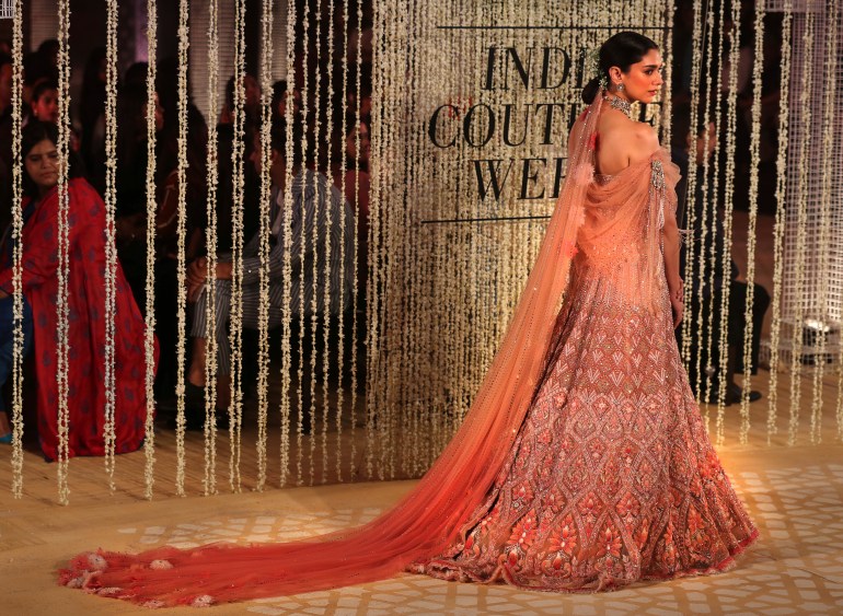 Bollywood actress Aditi Rao Hydari displays a creation of Indian designer Tarun Tahiliani during India Couture Week in New Delhi, India