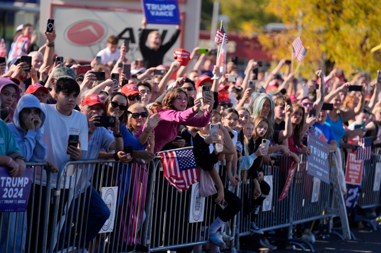 Crowds of supporters gather along the roadside near a McDonald's to cheer Donald Trump's photo op at the restaurant.