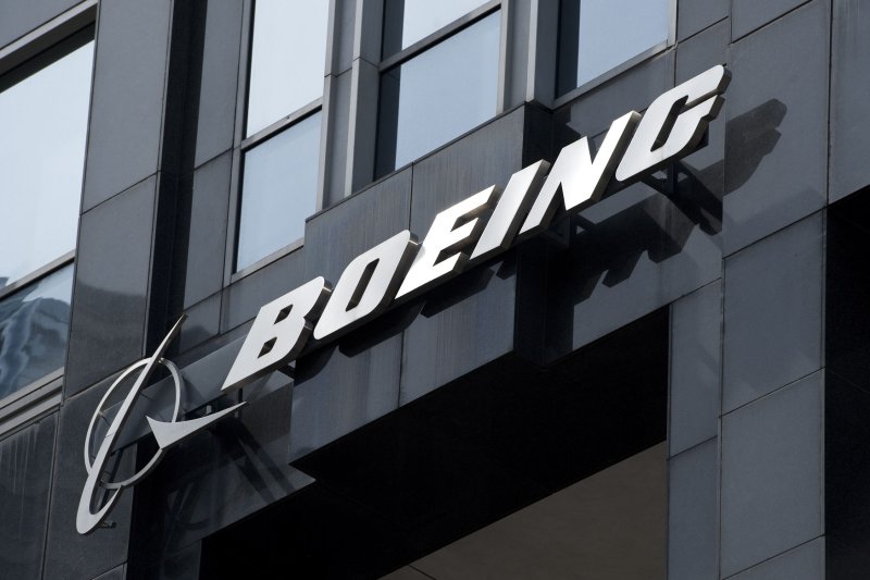 The Boeing logo hangs from the Boeing Building, international headquarters in Chicago on March 31, 2011. One of Boeing's key unions voted to approve a new contract on Monday. File Photo by Brian Kersey/UPI