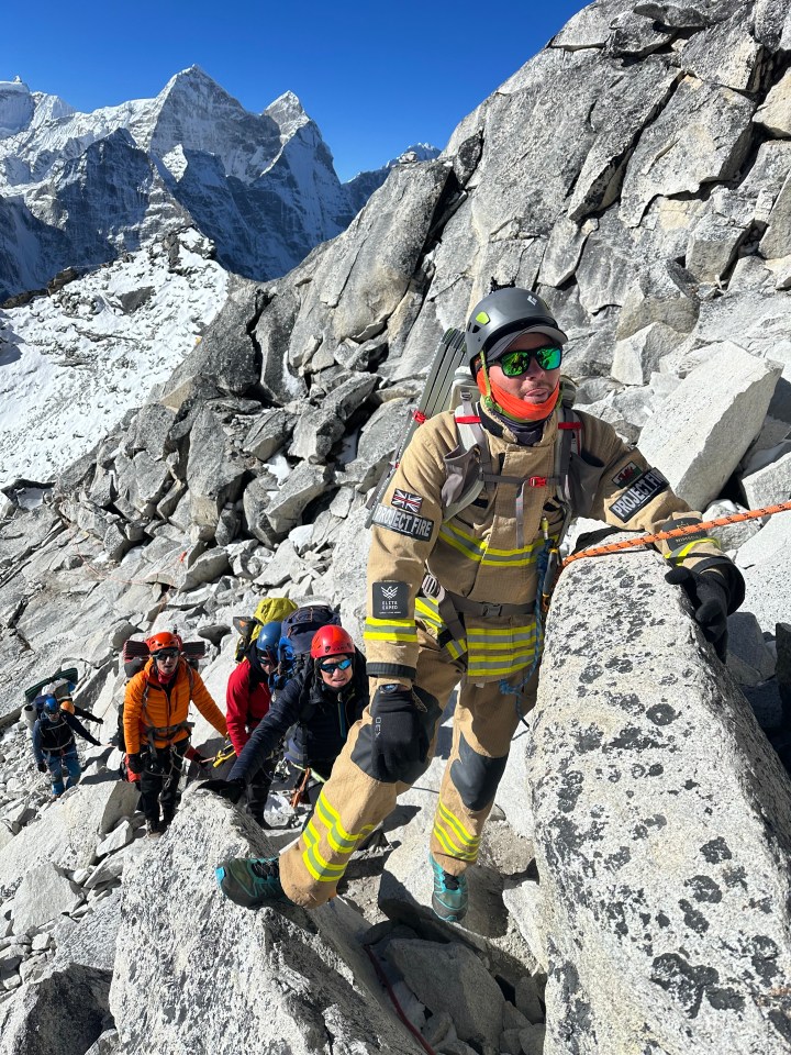 Fireman Rhys Fitzgerald, 28, climbing Ama Dablam - a 22,000ft mountain in the Himalayas - as he prepared to tackle Mt Everest in full fire gear