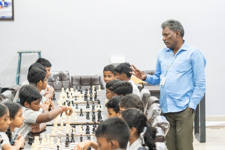 Coach Velavan Subbaiah guides his students as they face off against each other in practice games at his academy in Chennai, India 