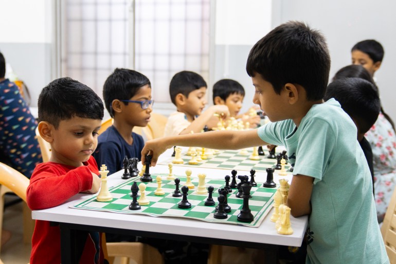 Children, some younger than four years old, practice chess at coach Ramesh's academy in Chennai, India