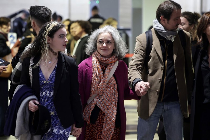 Samuel Paty's sister Gaelle Paty (C) arrives Monday morning at a specially formed Paris Assizes court where eight people are facing trial over their involvement in the beheading of French teacher Samuel Paty, just outside the capital in October 2020. Photo by Christophe Petit Tesson/EPA-EFE